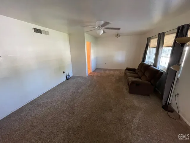a room with furniture and a ceiling fan
