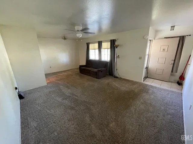 an empty room with windows and entrance