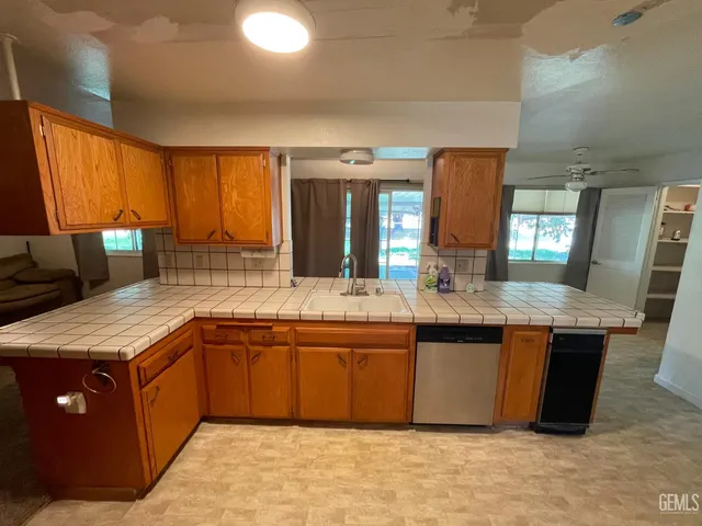 a spacious bathroom with a granite countertop sink and a mirror