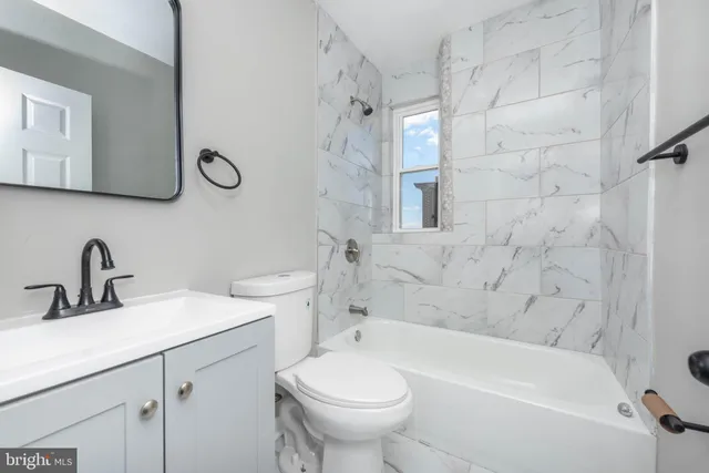 a bathroom with a sink a toilet and a bathtub