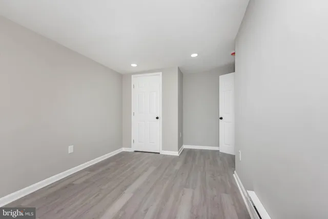 a view of a room with wooden floor