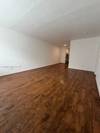an empty room with an empty space and wooden floor
