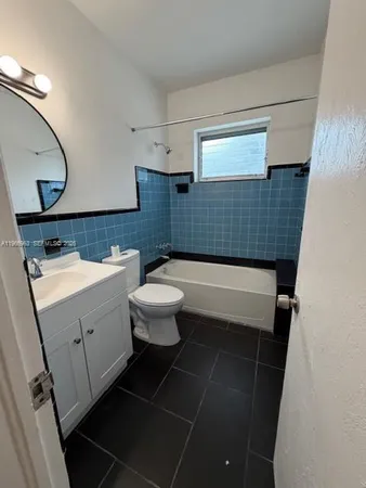 a bathroom with a sink mirror vanity and toilet