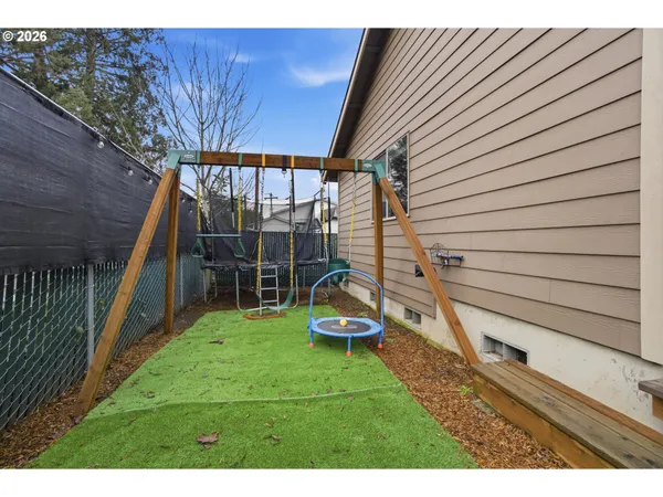 a view of a backyard with floor to ceiling window and brick wall