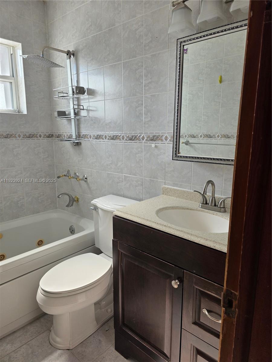 1560 West 53rd Terrace, Unit 1560 Hialeah, FL 33012 - Photo 17 of 28 a bathroom with a sink toilet and shower