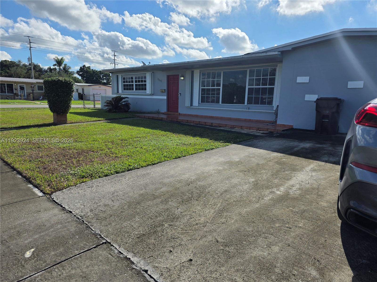 1560 West 53rd Terrace, Unit 1560 Hialeah, FL 33012 - Photo 2 of 28 a view of a house with a yard and many windows