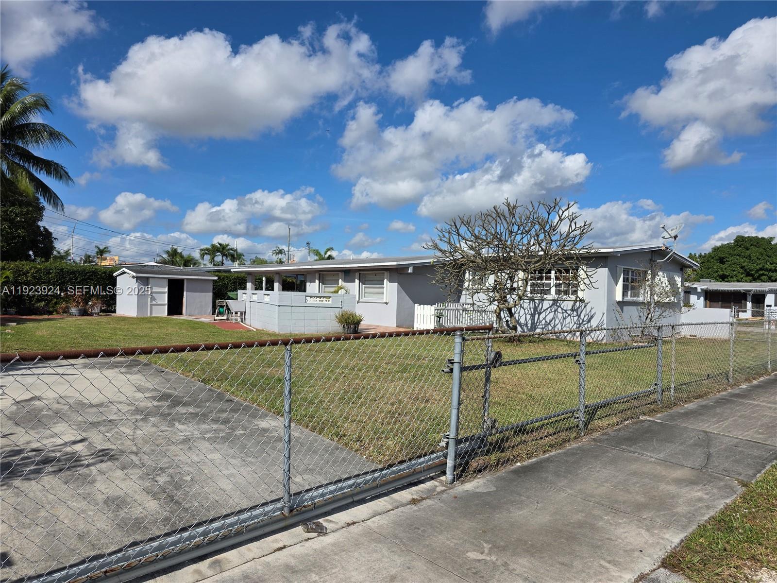 1560 West 53rd Terrace, Unit 1560 Hialeah, FL 33012 - Photo 25 of 28 a view of a house with a yard