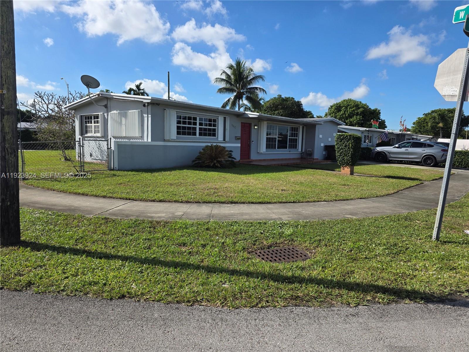 1560 West 53rd Terrace, Unit 1560 Hialeah, FL 33012 - Photo 26 of 28 a front view of a house with a yard