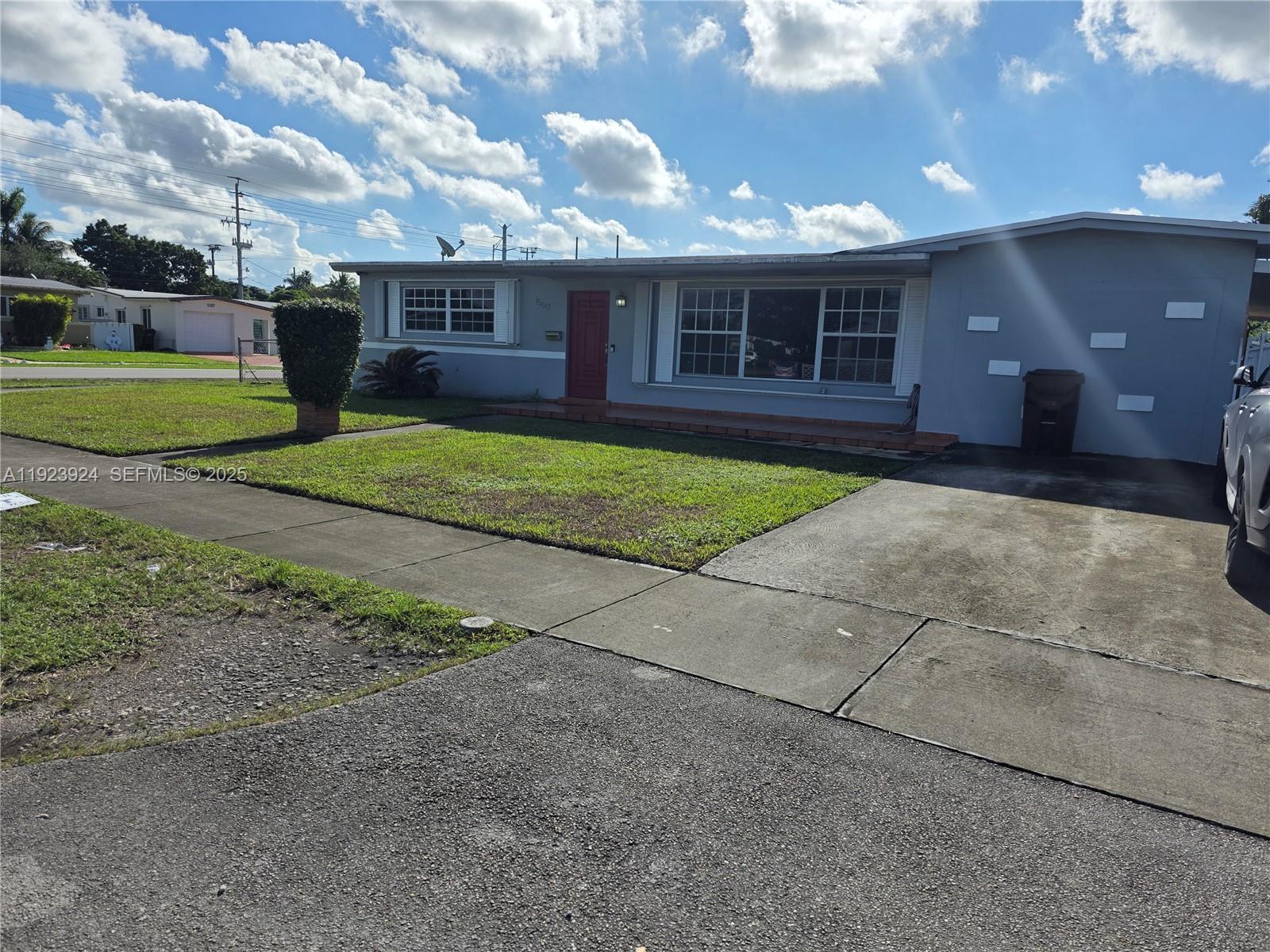 1560 West 53rd Terrace, Unit 1560 Hialeah, FL 33012 - Photo 28 of 28 a view of a house with a yard and large tree