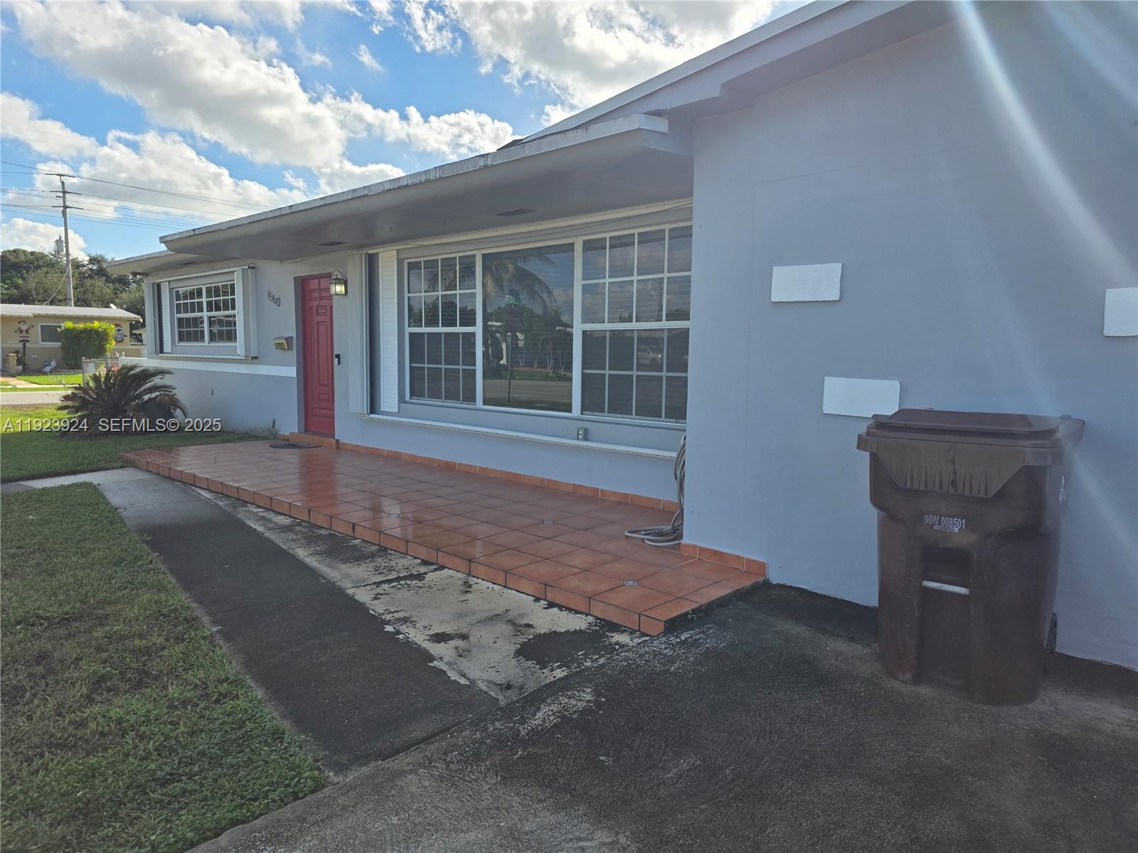 1560 West 53rd Terrace, Unit 1560 Hialeah, FL 33012 - Photo 3 of 28 a front view of a house with a yard