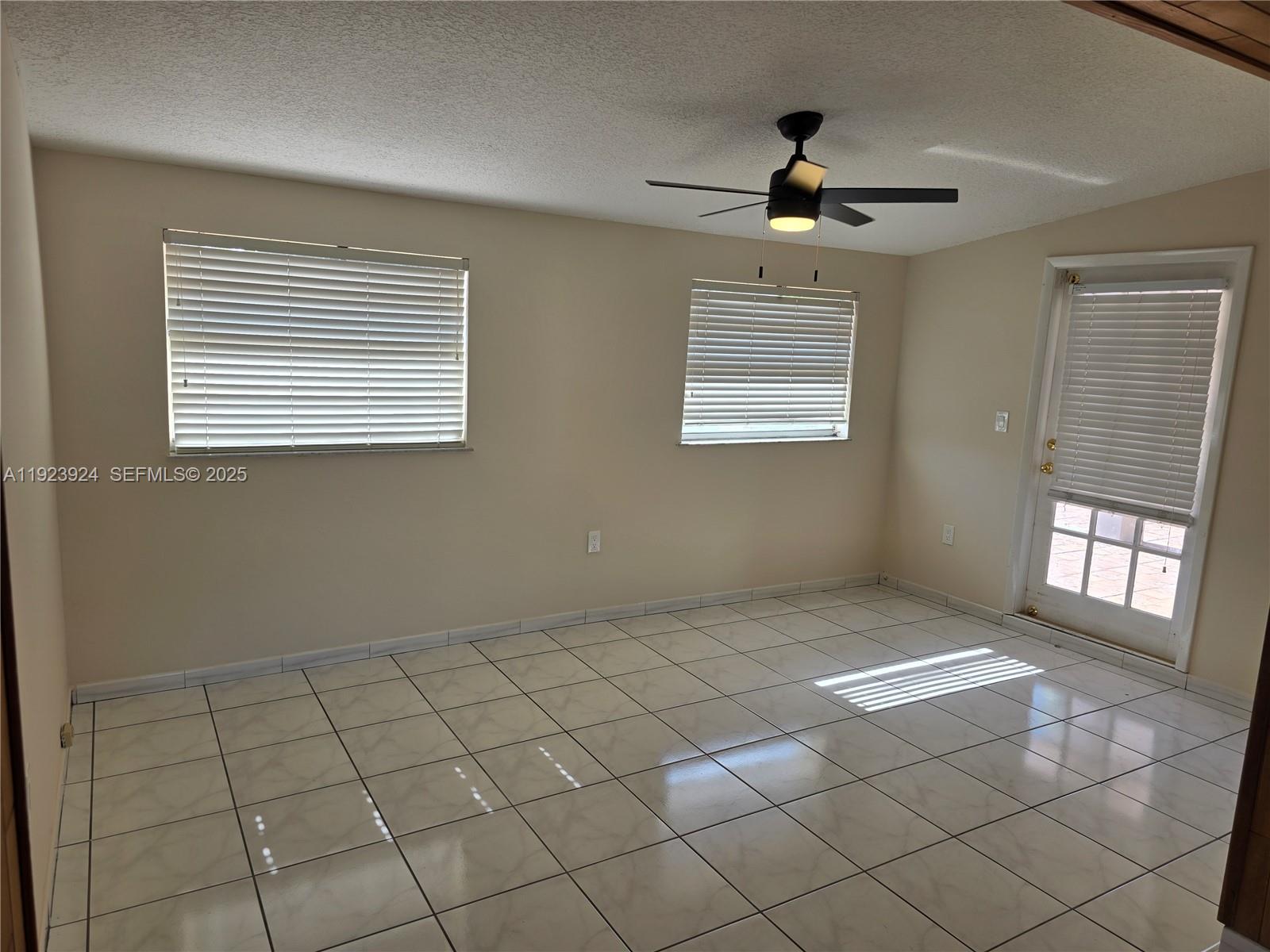1560 West 53rd Terrace, Unit 1560 Hialeah, FL 33012 - Photo 9 of 28 a view of an empty room and window