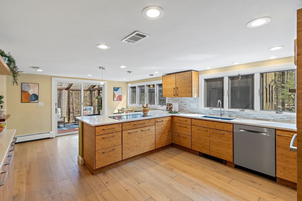 33 Turning Mill Road Lexington, MA 02420 - Photo 15 of 42 a large kitchen with wooden floors and stainless steel appliances