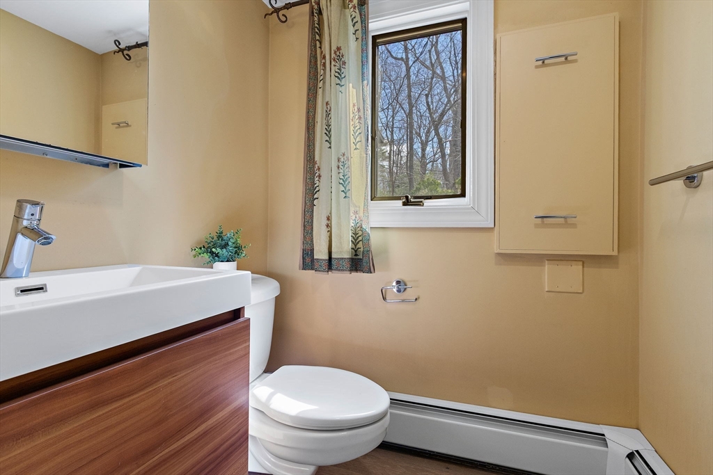 33 Turning Mill Road Lexington, MA 02420 - Photo 18 of 42 a bathroom with a sink a toilet and a window