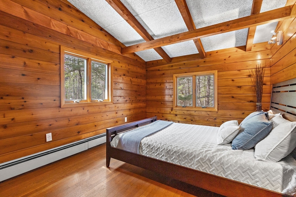 33 Turning Mill Road Lexington, MA 02420 - Photo 26 of 42 a bedroom with a bed and wooden floor