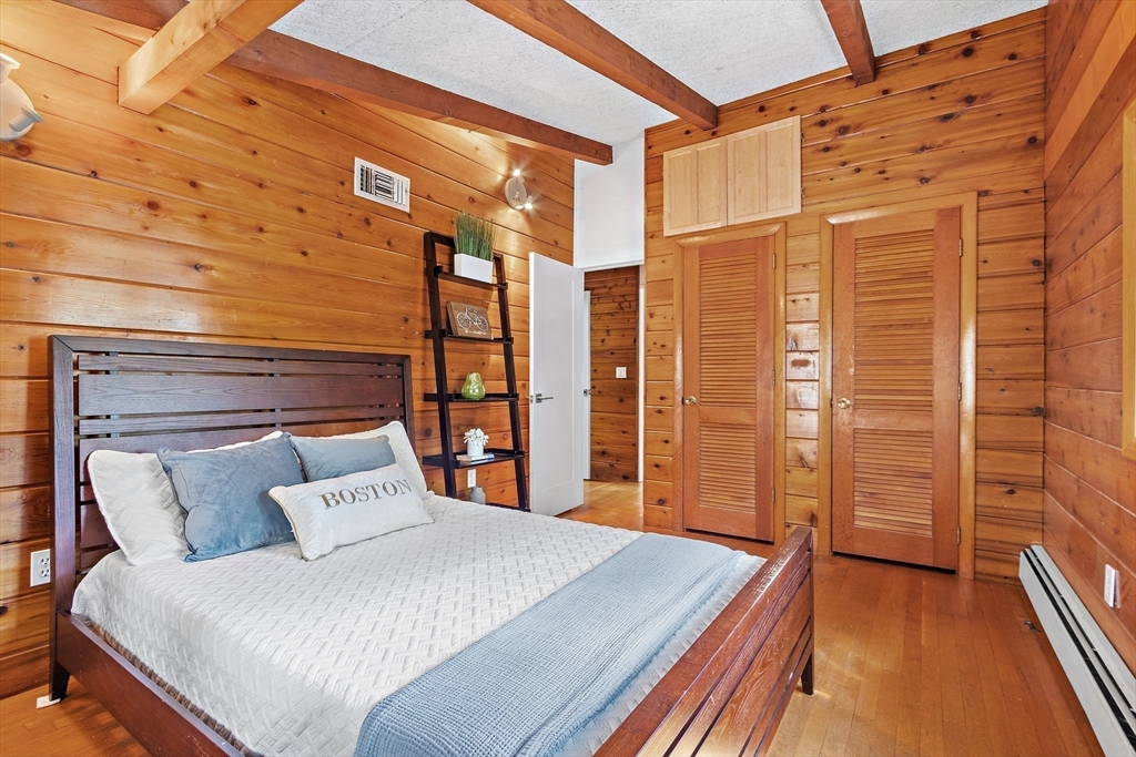 33 Turning Mill Road Lexington, MA 02420 - Photo 27 of 42 a bedroom with a large bed and a large window