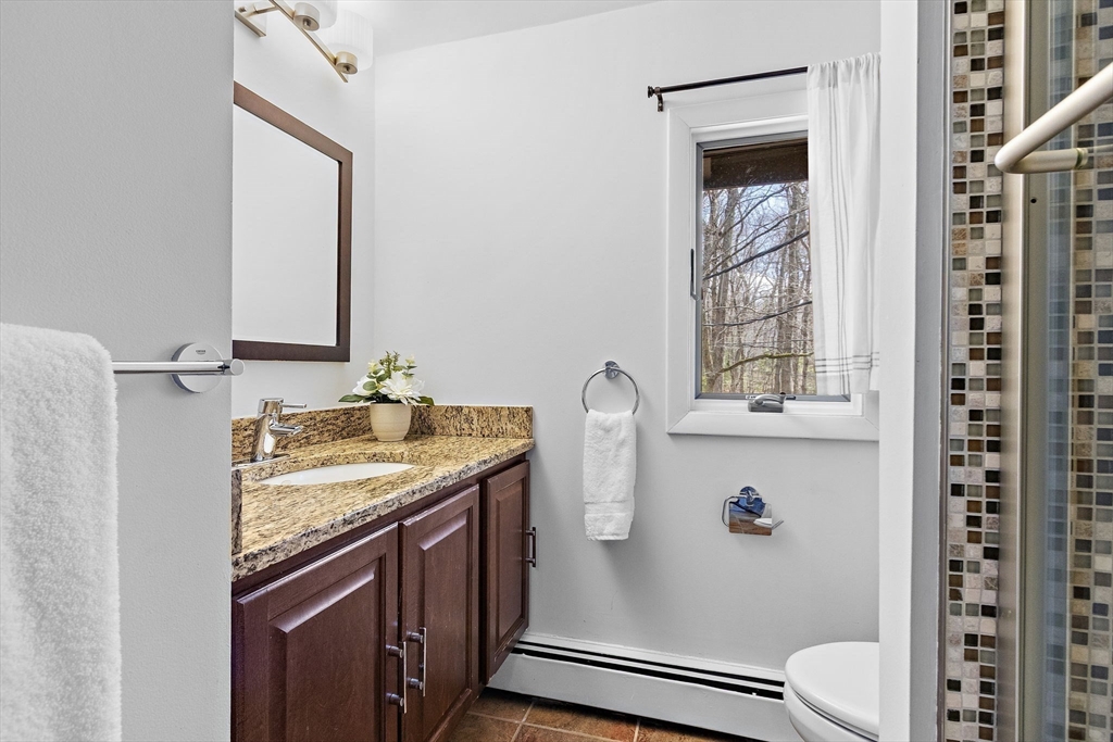 33 Turning Mill Road Lexington, MA 02420 - Photo 31 of 42 a bathroom with a granite countertop sink toilet and shower