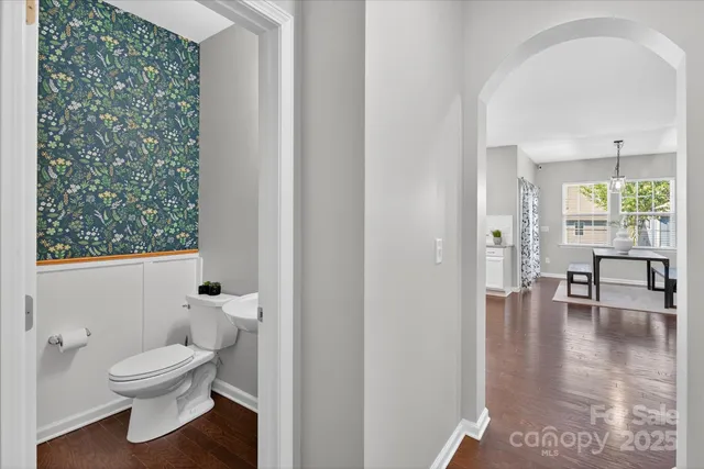 a bathroom with a toilet a sink and a window