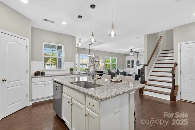 a kitchen with sink stove and cabinets