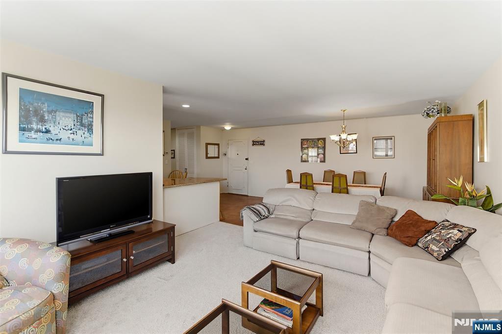 280 Prospect Avenue, Unit 8G Hackensack, NJ 07601 - Photo 11 of 23 a living room with furniture and a flat screen tv