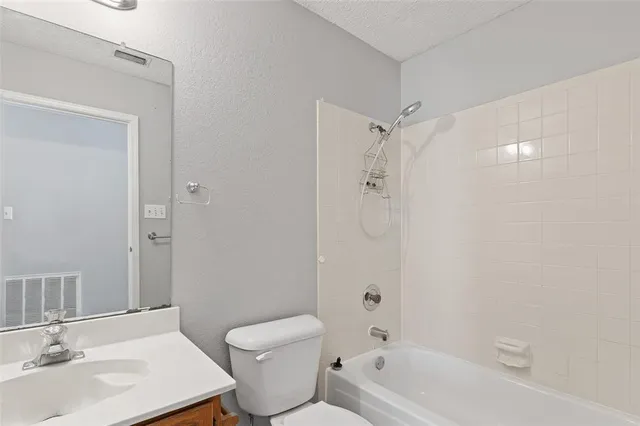 a view of a hallway with wooden floor and closet area