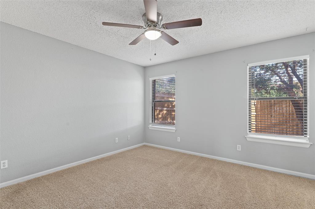 3521 Glenview Drive Corinth, TX 76210 - Photo 11 of 24 an empty room with a window and a fan