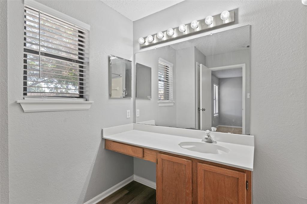 3521 Glenview Drive Corinth, TX 76210 - Photo 13 of 24 a bathroom with a sink and a mirror