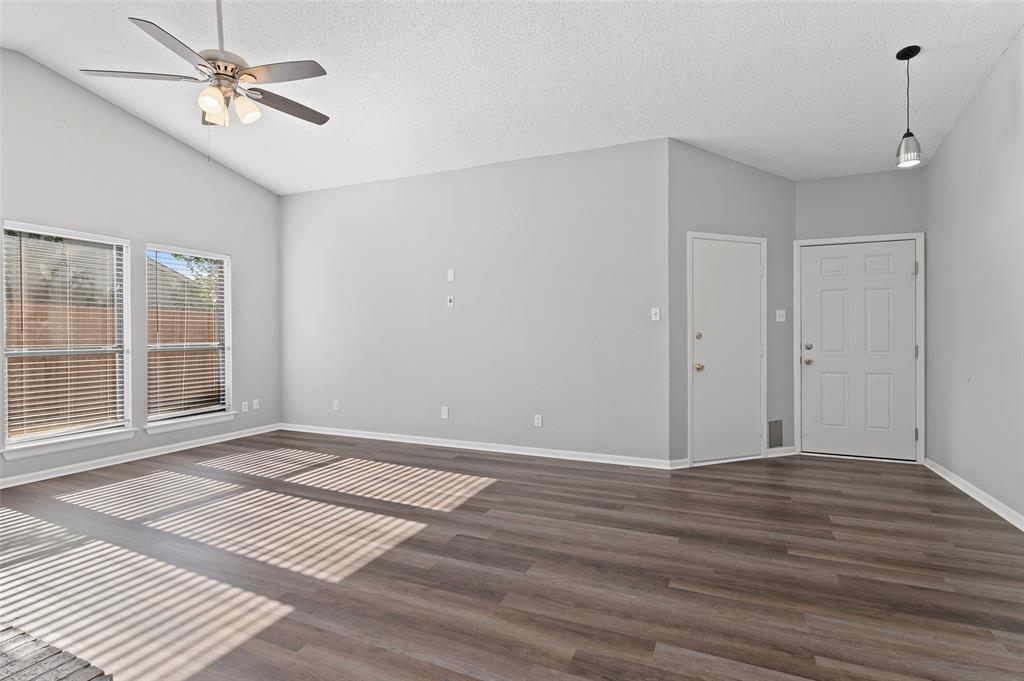 3521 Glenview Drive Corinth, TX 76210 - Photo 4 of 24 a view of an empty room with wooden floor and a window