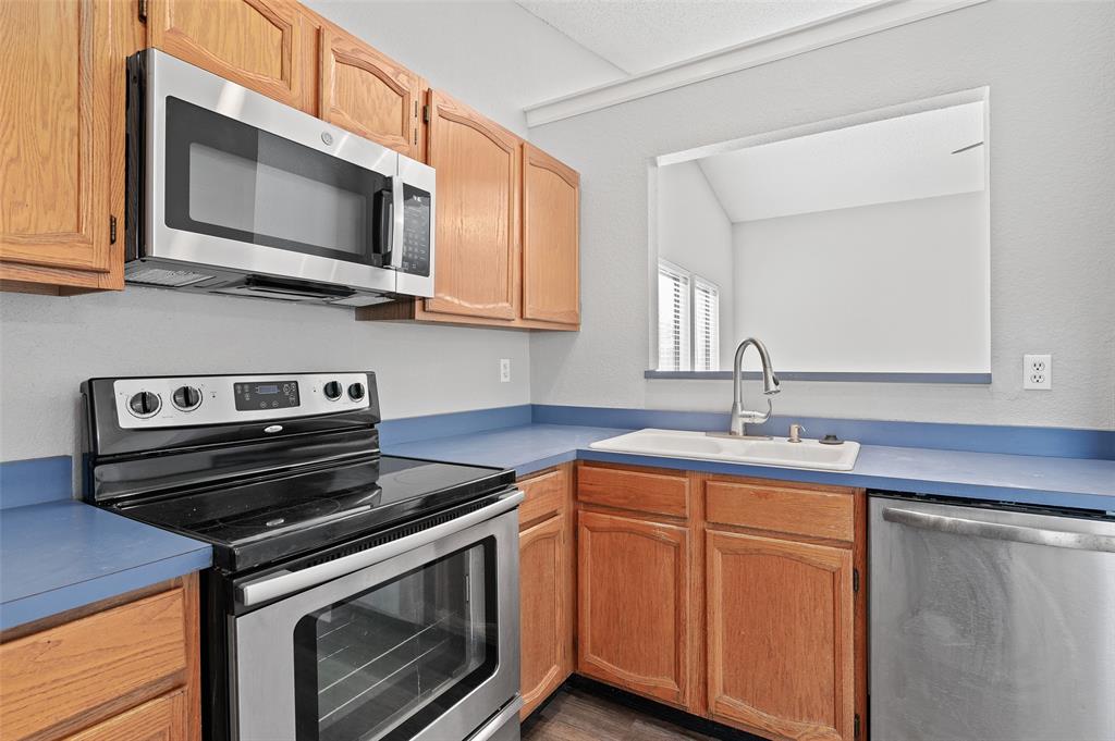 3521 Glenview Drive Corinth, TX 76210 - Photo 7 of 24 a kitchen with stainless steel appliances granite countertop a stove microwave and sink