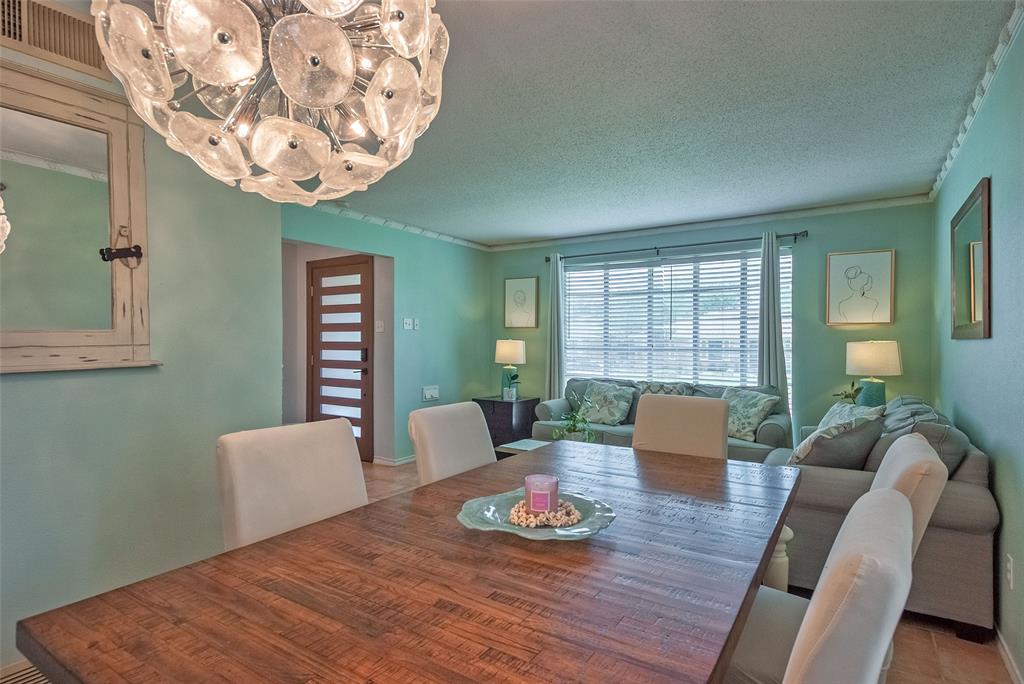 5739 Banting Way Dallas, TX 75227 - Photo 4 of 15 a view of a dining room with furniture a chandelier and wooden floor