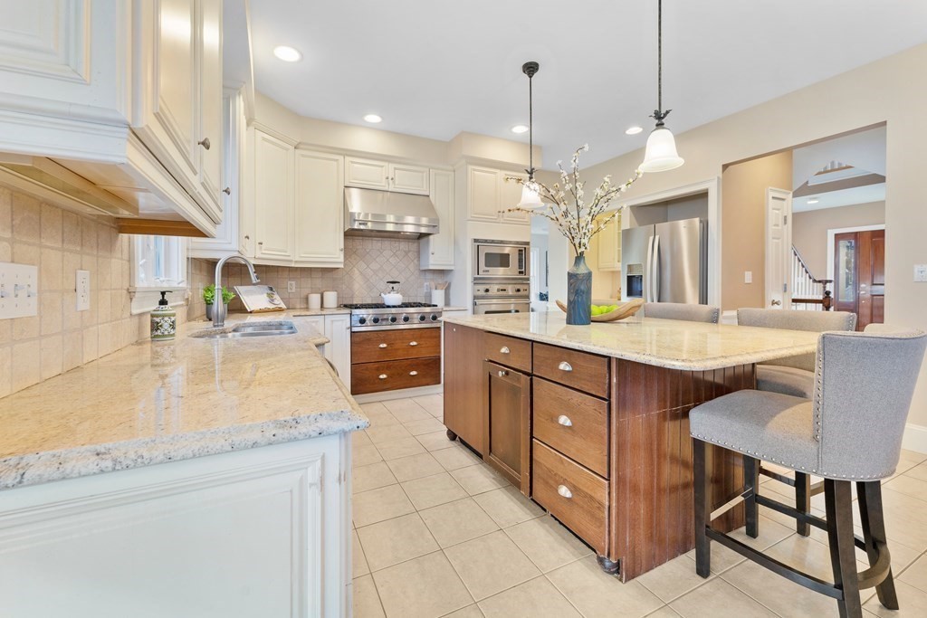 21 Ellison Road Lexington, MA 02421 - Photo 12 of 42 a large kitchen with kitchen island a large center island and stainless steel appliances