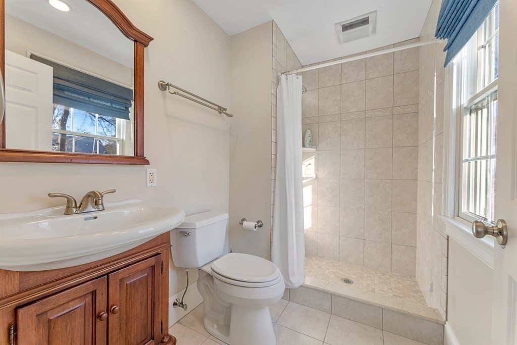 21 Ellison Road Lexington, MA 02421 - Photo 33 of 42 a bathroom with a sink a toilet and shower