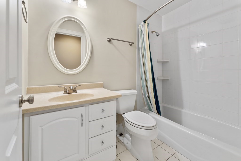 21 Ellison Road Lexington, MA 02421 - Photo 34 of 42 a bathroom with a toilet a sink a mirror a vanity and shower