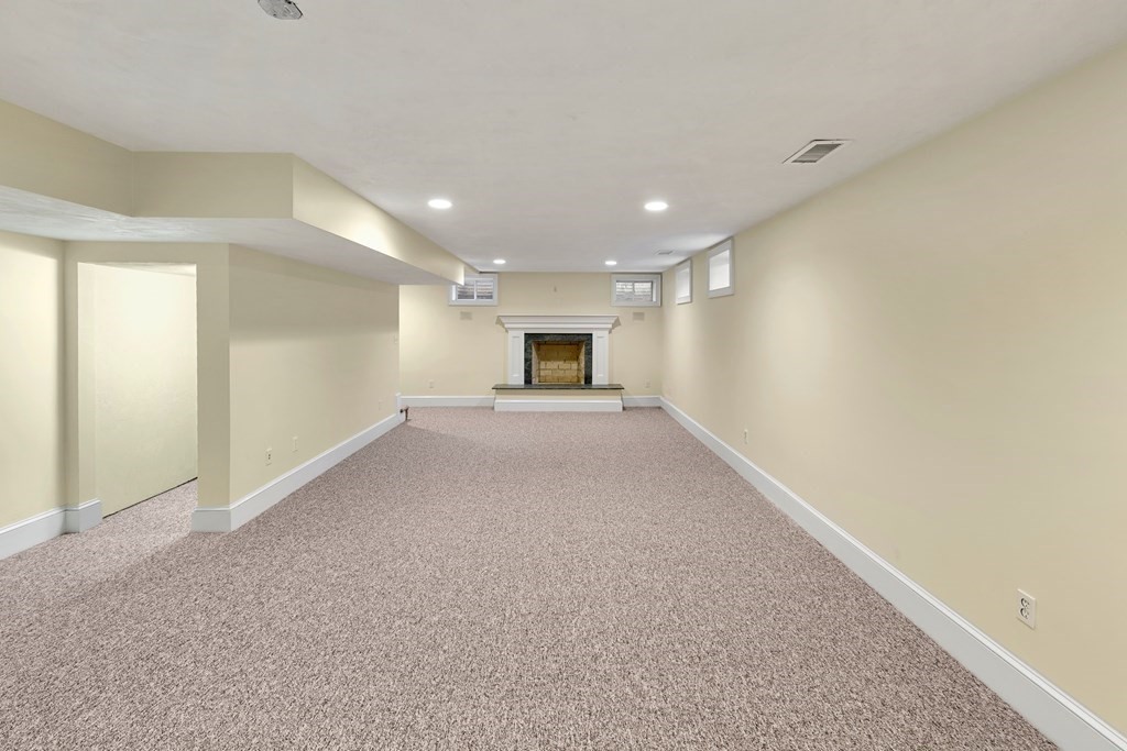 21 Ellison Road Lexington, MA 02421 - Photo 35 of 42 a view of an empty room and a fireplace