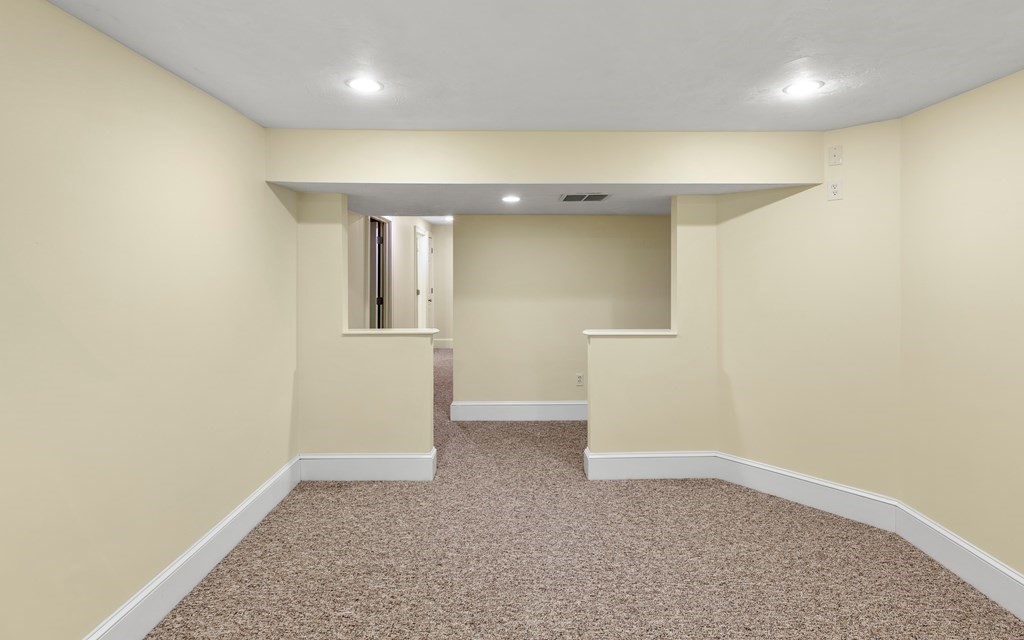 21 Ellison Road Lexington, MA 02421 - Photo 38 of 42 an empty room with wooden floor and windows