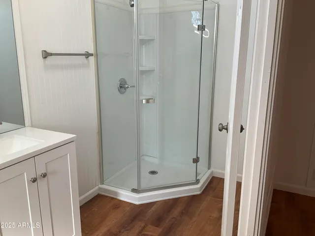 a bathroom with a glass shower door