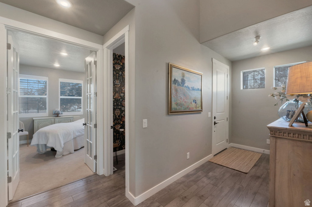 2319 North 3370 West Lehi, UT 84048 - Photo 12 of 30 Hallway featuring wood-finish flooring, recessed lighting, and a solid panel door