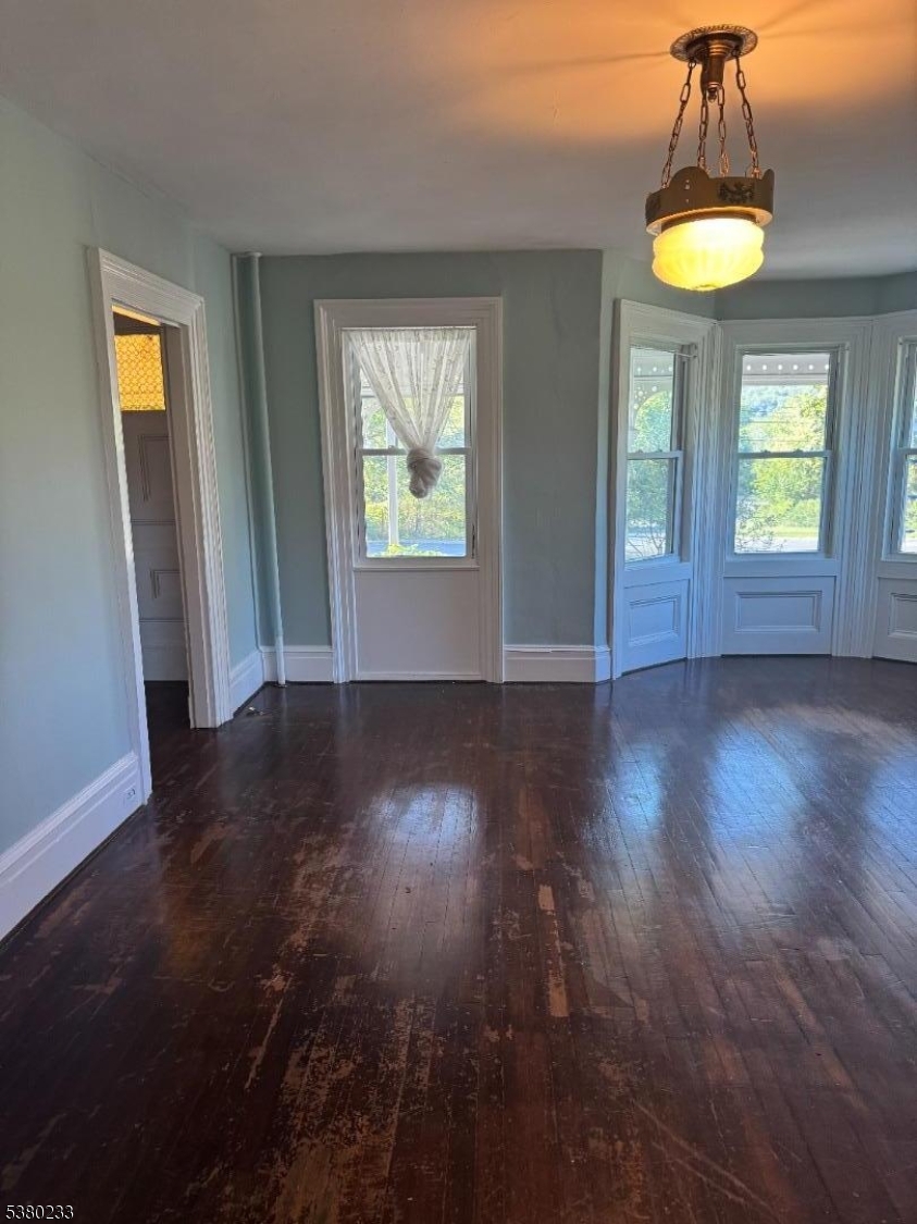 168 East Main Street Lebanon, NJ 08833 - Photo 11 of 26 an empty room with wooden floor and windows