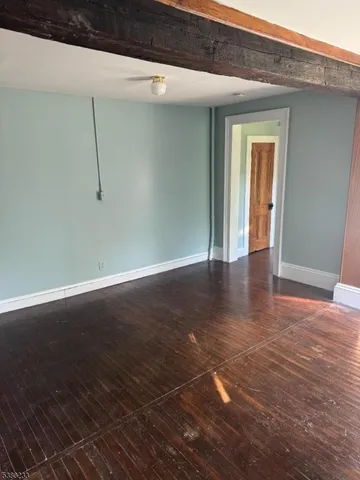 a view of a room with wooden floor