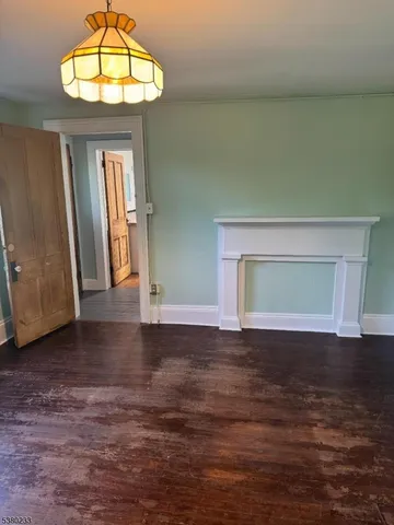 a view of room with window and wooden floor