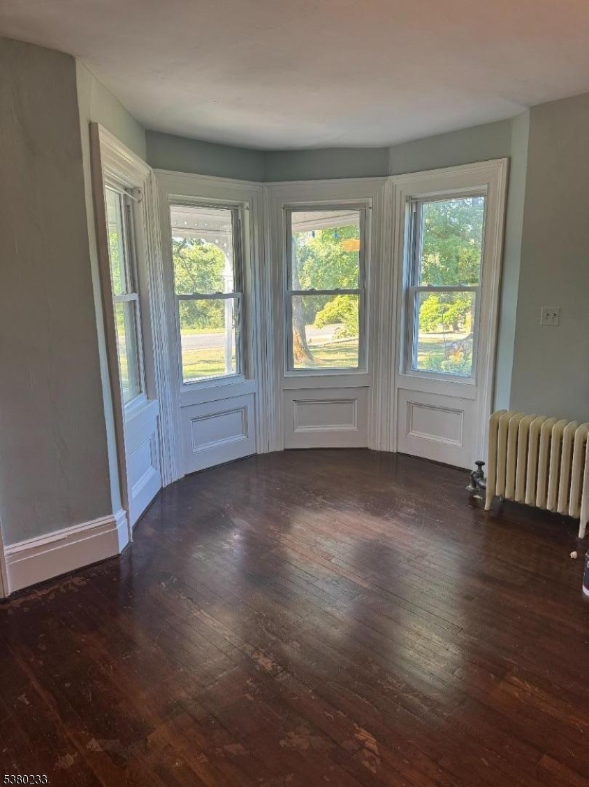 168 East Main Street Lebanon, NJ 08833 - Photo 10 of 26 an empty room with wooden floor and windows