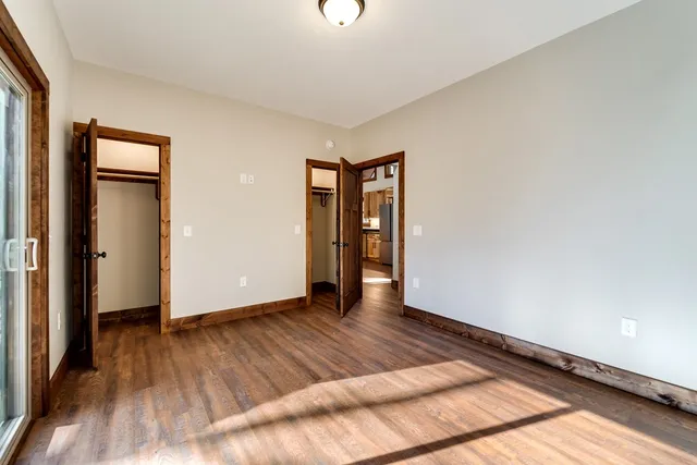 a view of an empty room and wooden floor