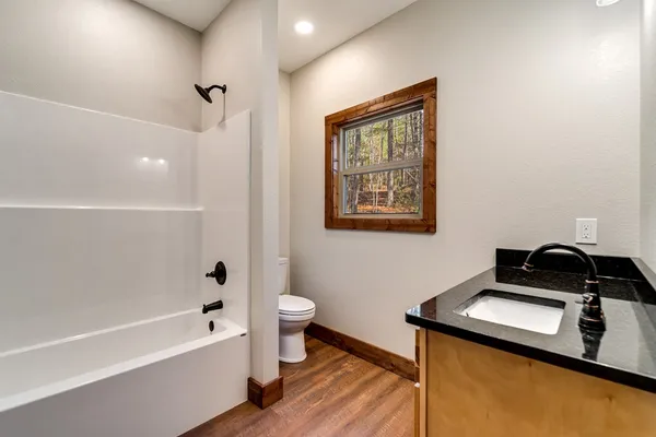 a bathroom with a bathtub sink and toilet