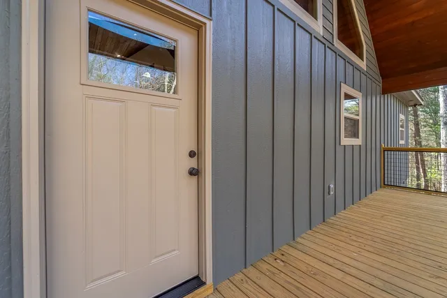 a view of a hallway with wooden floor and entryway