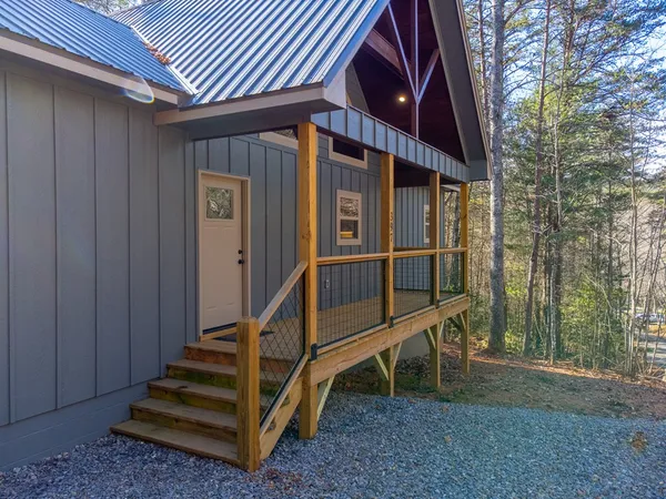 a view of wooden house with a large window
