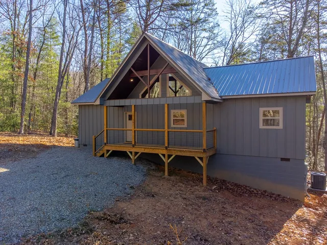 a view of a house with a small yard and wooden fence