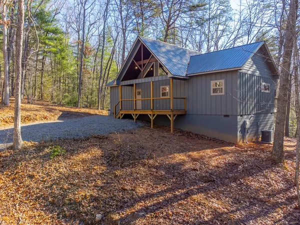 a view of a house with yard and a trees