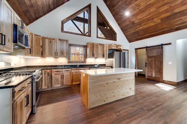 a kitchen with stainless steel appliances granite countertop a stove and a sink