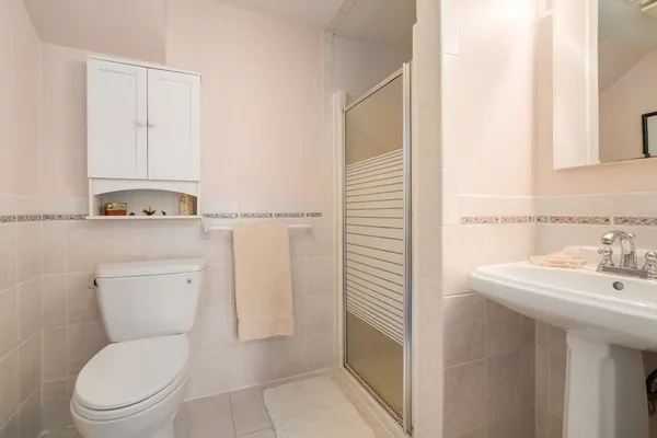 a bathroom with a toilet a sink and a mirror