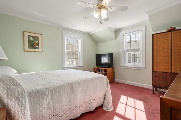 a bedroom with a bed and a tv