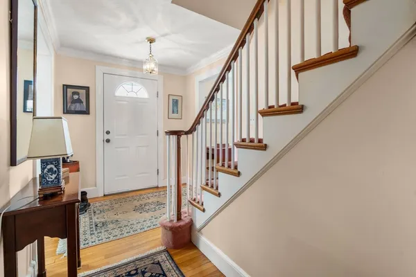 a view of entryway and hall with wooden floor